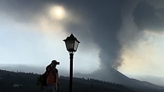 Tourist filming the volcano with his mobile phone