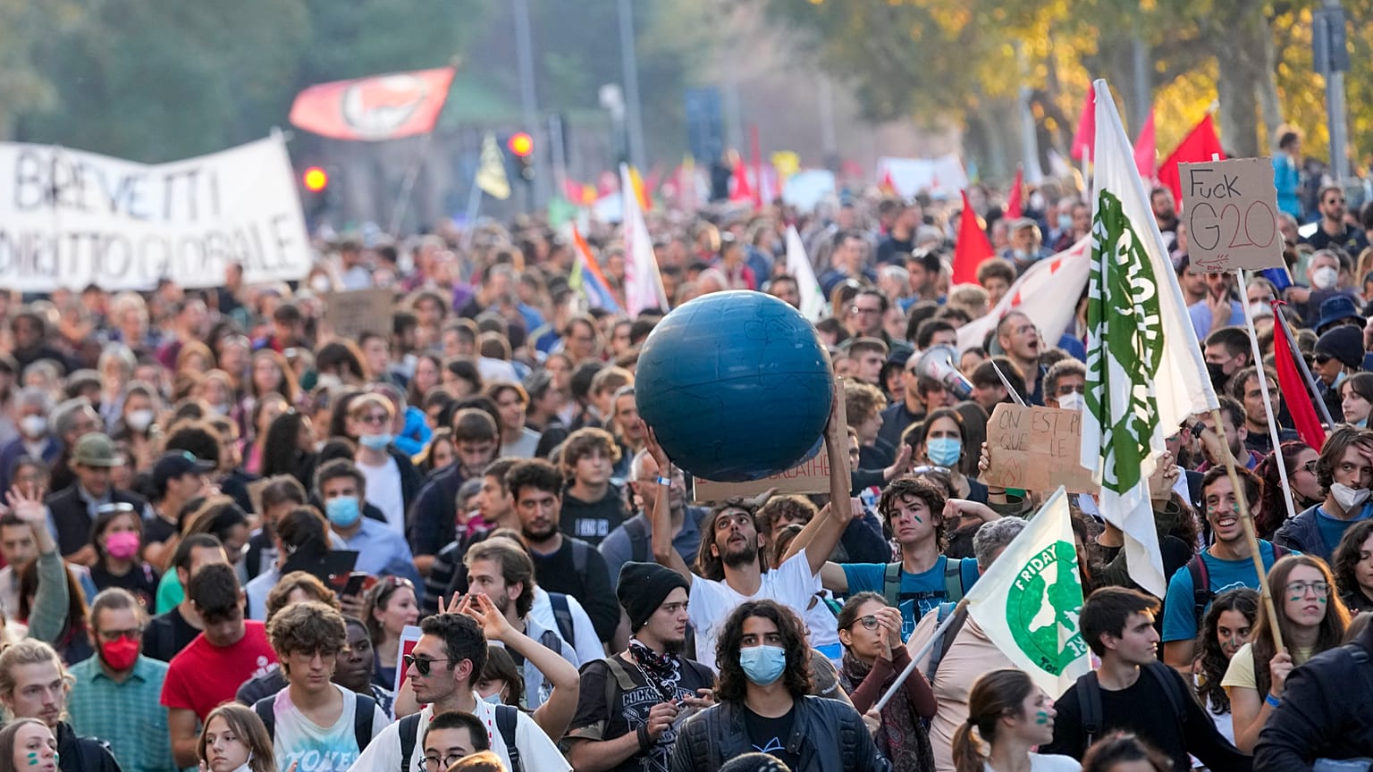 Demonstrators march in Rome, Saturday, Oct. 30, 2021, the day a Group of 20 summit started in the Italian capital.