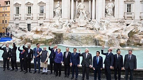 Leaders of the G20 throw coins inside the Trevi Fountain.