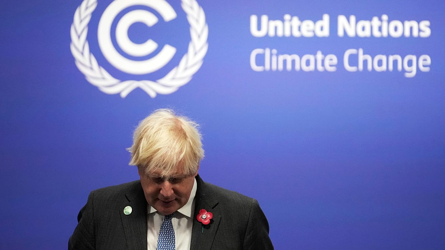 British Prime Minister Boris Johnson waits to receive attendees, at the COP26 U.N. Climate Summit in Glasgow, Scotland, Monday, Nov. 1, 2021. 