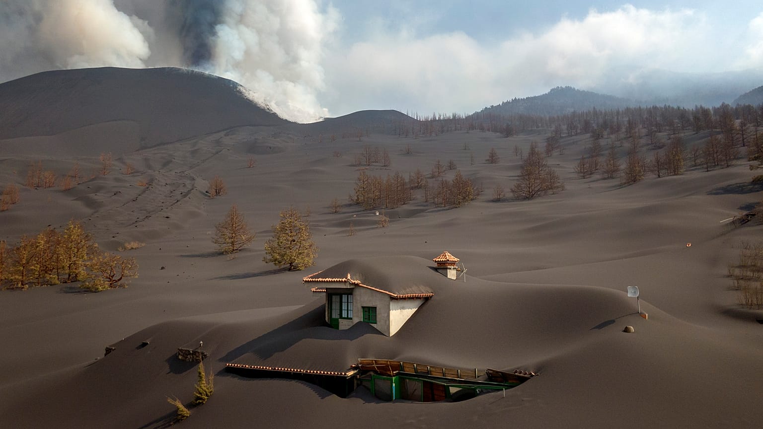 A house is covered by ash from a volcano as it continues to erupt on the Canary island of La Palma, Spain.