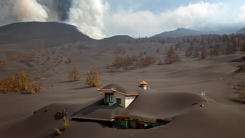 A house is covered by ash from a volcano as it continues to erupt on the Canary island of La Palma, Spain.