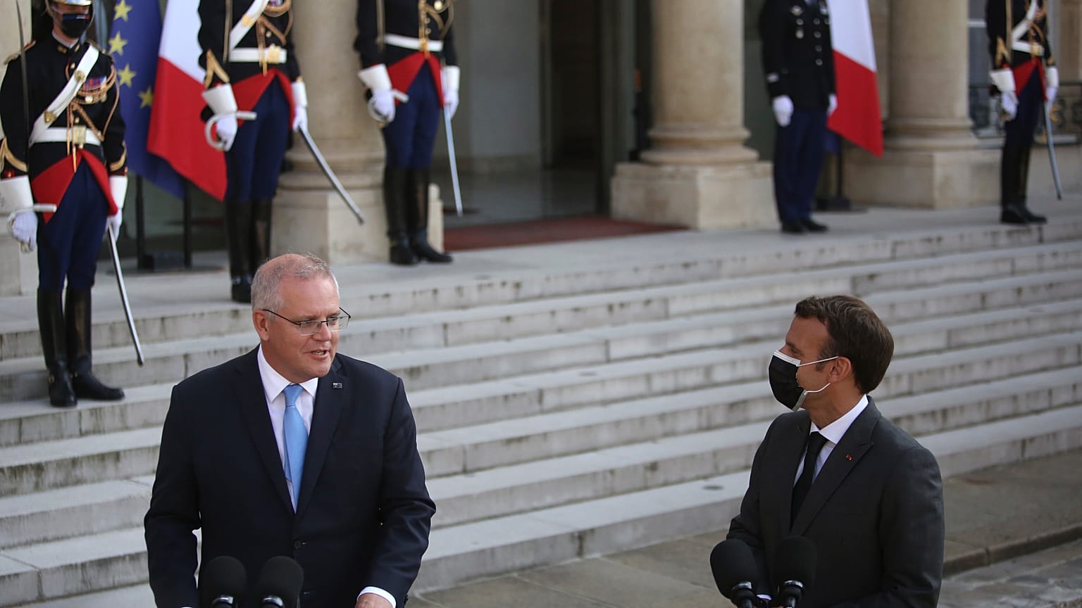 French President Emmanuel Macron, right, watches Australia's Prime Minister Scott Morrison