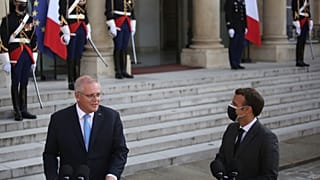 French President Emmanuel Macron, right, watches Australia's Prime Minister Scott Morrison