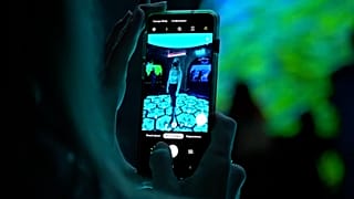 A visitor takes a photo inside a new exhibition entitled 'Digital Twins' in the Zifergauz gallery in St Petersburg, Russia.