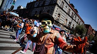 Participants wearing skull masks perform during the annual Day of the Dead parade in Mexico City, Mexico, October 31, 2021.