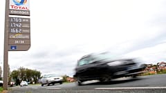 Cars pass by a gas station in Saint Jean de Luz, southwestern France, on Friday, October 22
