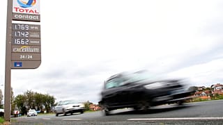 Cars pass by a gas station in Saint Jean de Luz, southwestern France, on Friday, October 22