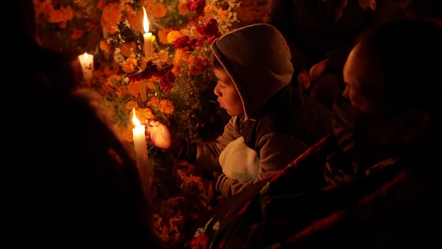 Family holding vigil around family grave  