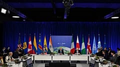 US President Joe Biden (C), flanked by President of the European Commission Ursula von der Leyen (L) and British Prime Minister Boris Johnson (R), speaks  at COP26.