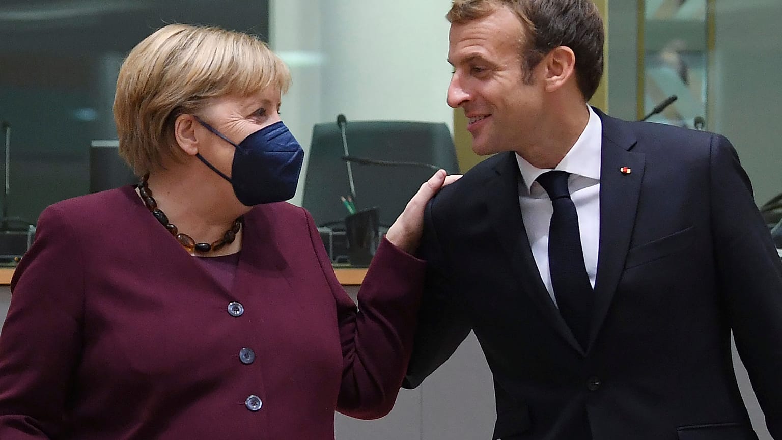 French President Emmanuel Macron, right, and German Chancellor Angela Merkel during a round table meeting at an EU summit in Brussels, Oct. 22, 2021. 