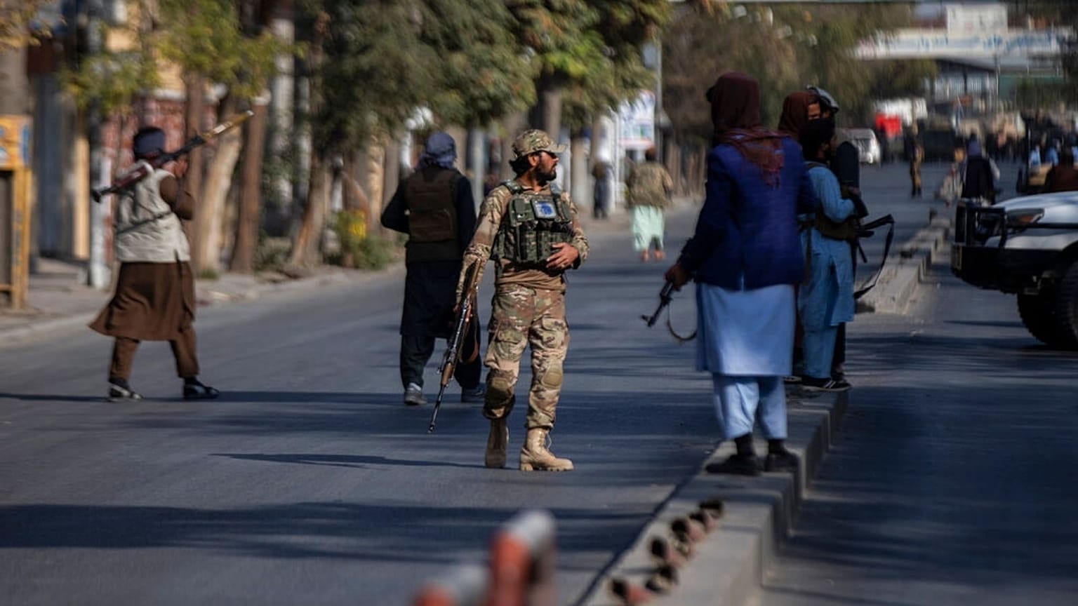 Taliban fighters block roads after an explosion Tuesday, Nov. 2, 2021