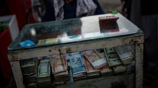 An Afghan money changer waits for customers in Kabul's Old City
