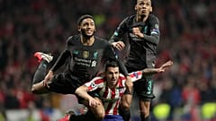 Liverpool's Fabinho, right, and Joe Gomez jump for a header with Atletico Madrid's Vitolo