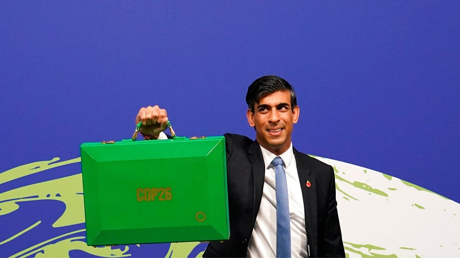 Britain's Chancellor of the Exchequer Rishi Sunak holds up a Green briefcase as he arrives for a speech at the COP26 U.N. Climate Summit in Glasgow, Nov. 3, 2021. 