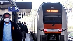 Passengers walk along a platform as a train with the inscription "Do not board" leaves the main station in Duesseldorf, Germany, Tuesday, Aug. 24, 2021. 