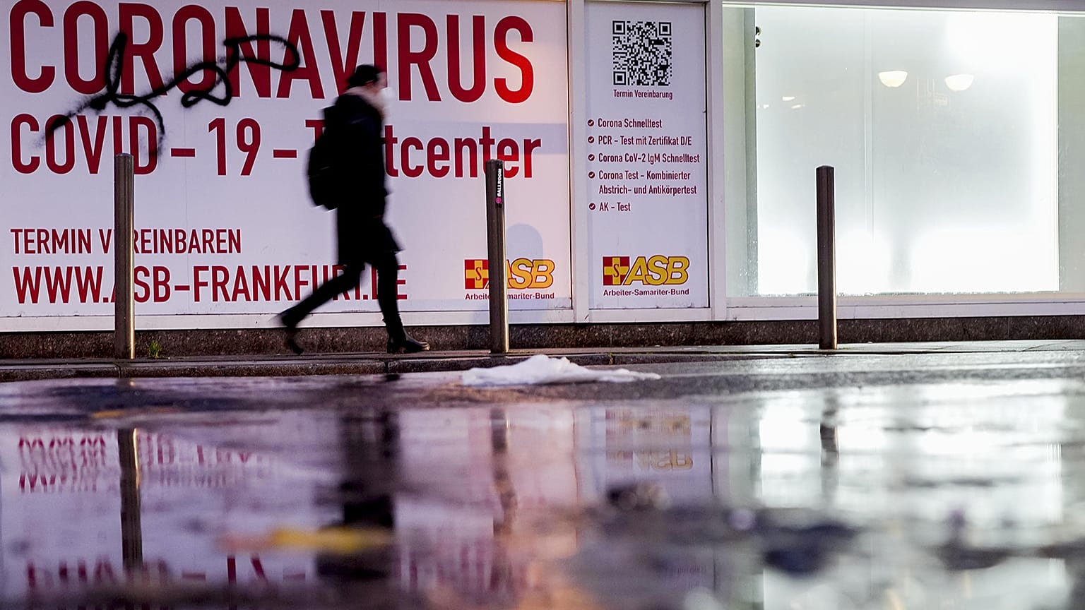 A woman walks past an abandoned coronavirus test center in Frankfurt, Tuesday, Nov. 2, 2021. 