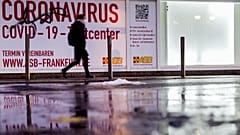 A woman walks past an abandoned coronavirus test center in Frankfurt, Tuesday, Nov. 2, 2021. 