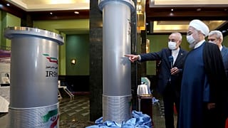 President Hassan Rouhani (R) listens to head of the Atomic Energy Organization while visiting an exhibition of Iran's new nuclear achievements in Tehran on April 10, 2021. 
