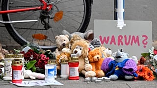 Tributes at the apartment building in Solingen where five children were found dead.