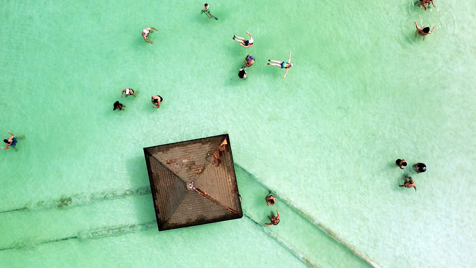Visitors bathe in the Dead Sea near Ein Bokek, Israel, October 30, 2021. 