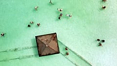 Visitors bathe in the Dead Sea near Ein Bokek, Israel, October 30, 2021. 