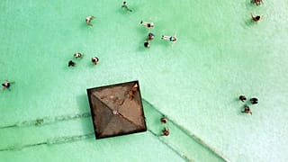 Visitors bathe in the Dead Sea near Ein Bokek, Israel, October 30, 2021.