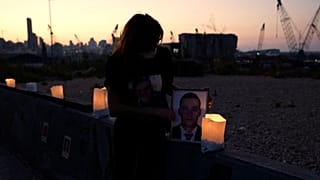 woman holding a photo of a loved one killed in the Beirut port blast.