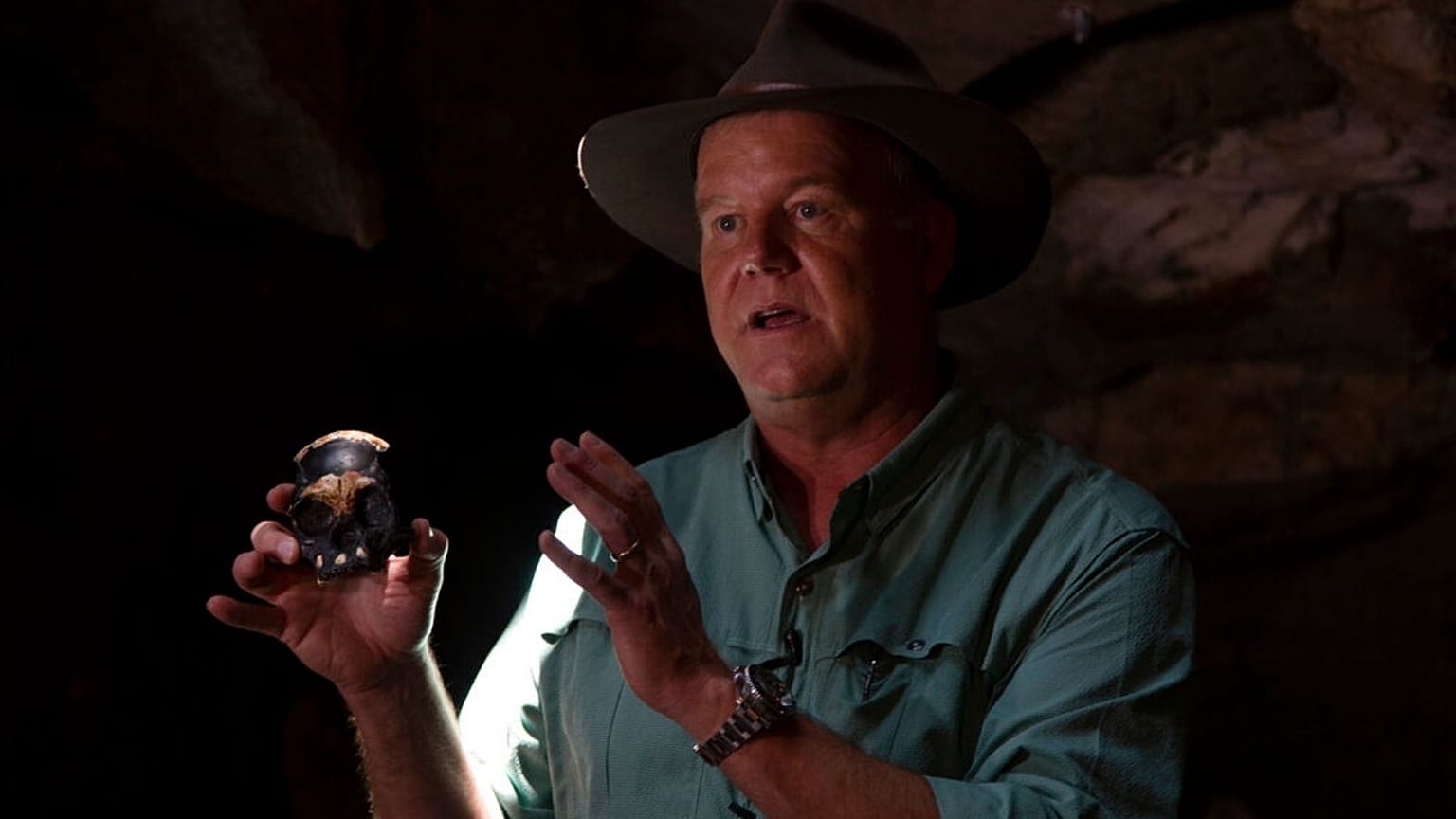 Professor Lee Berger, holds a replica of the discovered Homo Naledi fossil
