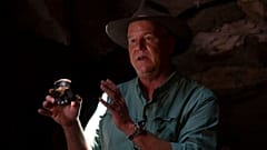Professor Lee Berger, holds a replica of the discovered Homo Naledi fossil