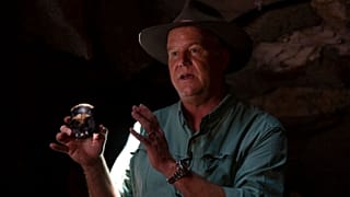 Professor Lee Berger, holds a replica of the discovered Homo Naledi fossil