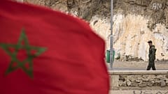 A picture taken from the Moroccan region of Oujda shows an Algerian border guard patrolling along the border with Morocco on November 4, 2021.