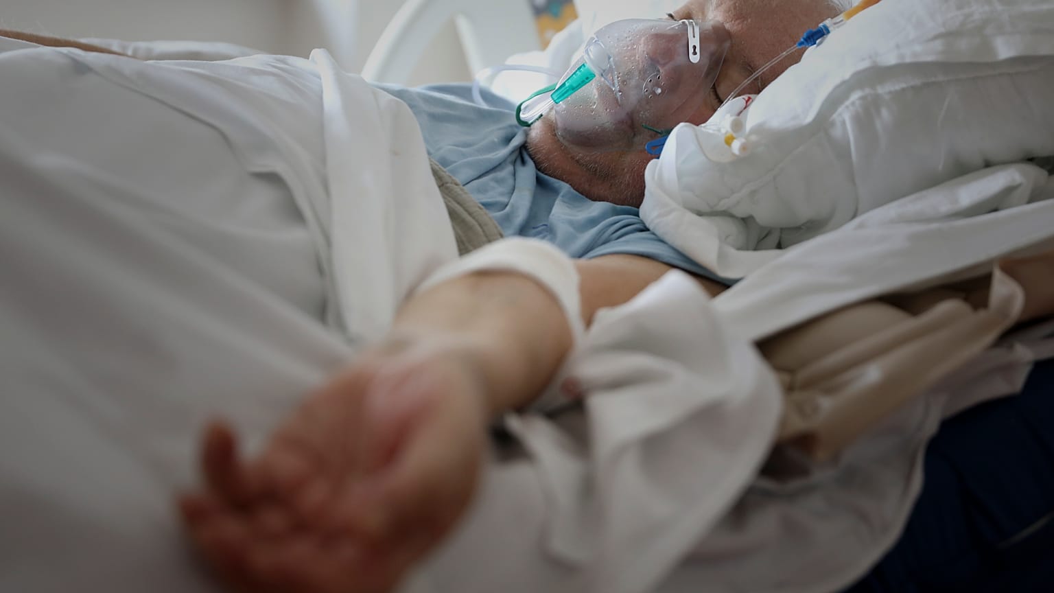 A patient breathes through an oxygen mask in the COVID-19 section of the University Clinical Centre hospital in Banja Luka, Bosnia, Thursday, Nov. 4, 2021.