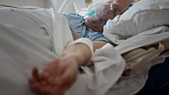 A patient breathes through an oxygen mask in the COVID-19 section of the University Clinical Centre hospital in Banja Luka, Bosnia, Thursday, Nov. 4, 2021.