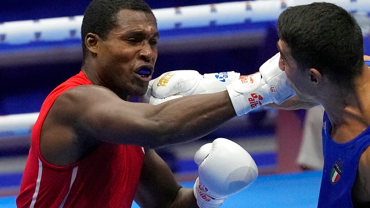 Cuba's Julio La Cruz Peraza, left, fights with Italy's Aziz Abbes Mouhiidine during the men's Heavyweight final of the AIBA World Boxing Championships 2021