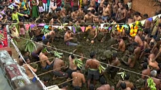 Villagers throwing cow dung at each other