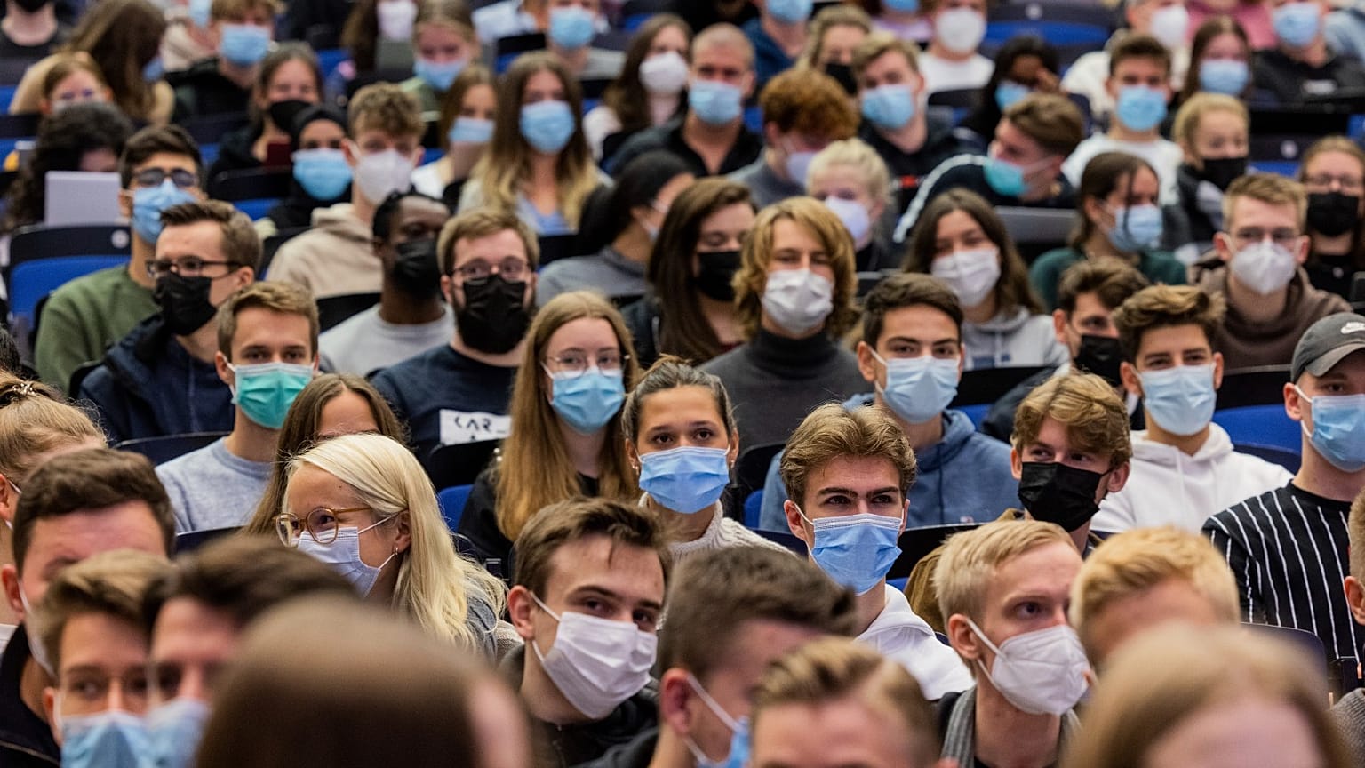 Students wear mouth-to-nose coverings while sitting close to each other during the lecture 'BWL 1' in lecture hall H1 of the Westfaelische Wilhelms-Universitaet in Muenster