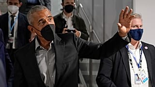 Former US President Barack Obama waves as he arrives at an event during the COP26 UN Climate Summit in Glasgow, Scotland, Monday, Nov. 8, 2021