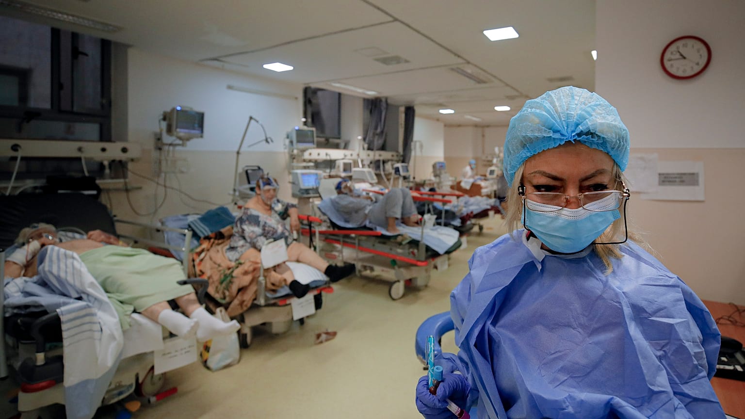 Patients lie on beds in a crowded COVID-19 isolation room at the University Emergency Hospital in Bucharest, Romania, Friday, Oct. 22, 2021.