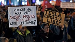 Demonstrators hold a banner reading 'why are you accepting abusive electricity taxes without complaining?' during a protest against rising electricity prices, in Barcelona.