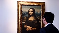 Auctioneer Matthieu Fournier displays the copy of Leonardo da Vinci's Mona Lisa 