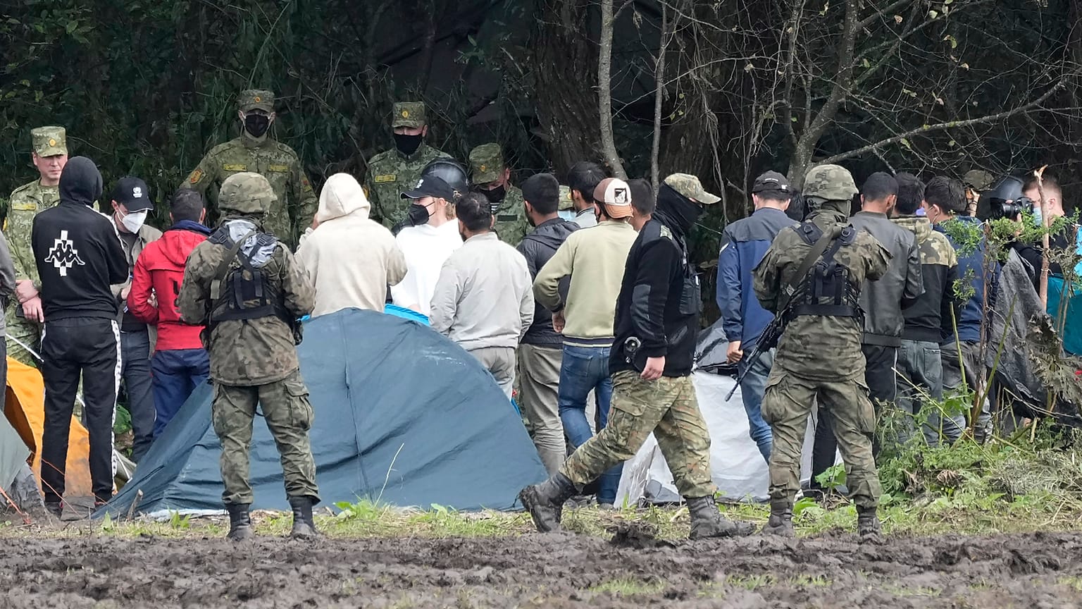FILE - Polish security forces block migrants on the border with Belarus in Usnarz Gorny, Poland, on Wednesday, Sept. 1, 2021.