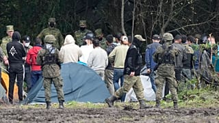 FILE - Polish security forces block migrants on the border with Belarus in Usnarz Gorny, Poland, on Wednesday, Sept. 1, 2021.