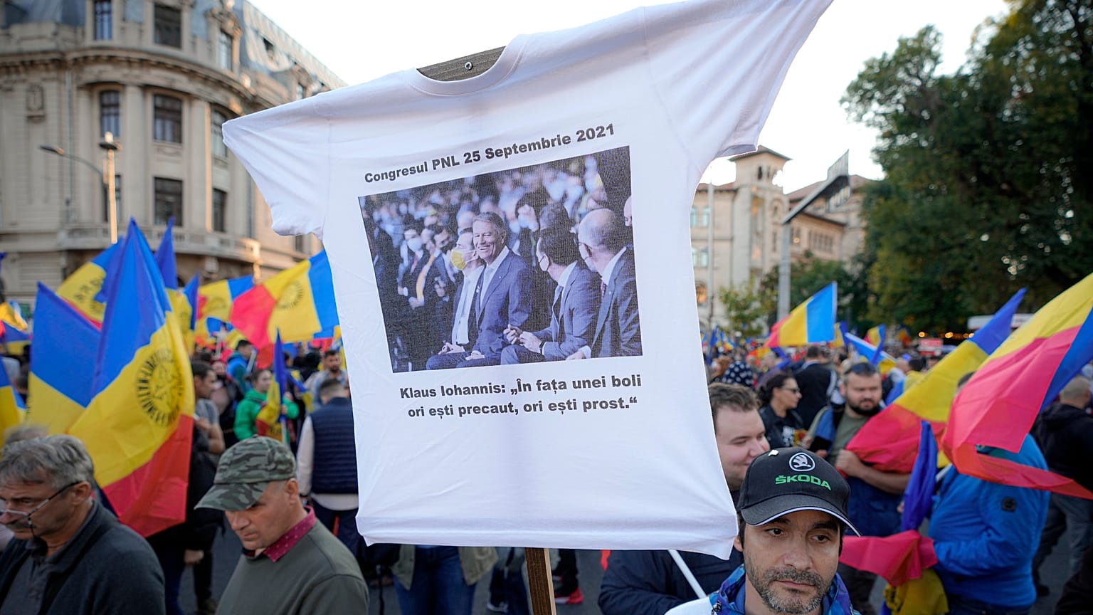 A man holds a t-shirt with a picture showing Romania's president Klaus iohannis at the ruling Liberal Party congress.