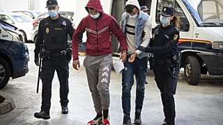 Two of the suspects are escorted by police officers to the courthouse in Palma de Mallorca.