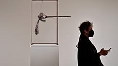 A person walks past Alberto Giacometti's "Le Nez", part of The Macklowe Collection, at Sotheby's on November 5, 2021 in New York City.