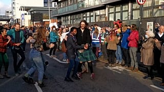 Guitarist in a kilt leads spontaneous dance action outside COP26