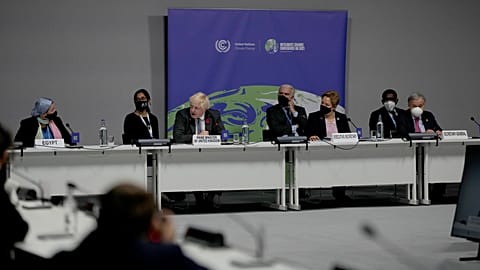 Boris Johnson speaks next to UN Secretary-General Antonio Guterres and UNFCCC Executive Secretary Patricia Espinosa at COP26 in Glasgow, Scotland, Wednesday, Nov. 10, 2021. 