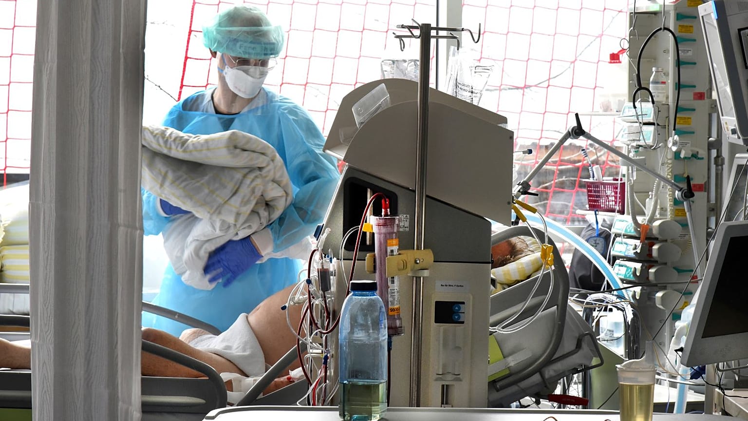 A nurse cares for a patient in the Covid 19 ward at Leipzig University Hospital in Germany.