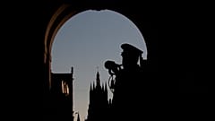 A lone bugler plays the nightly Last Post under the World War I monument, Menin Gate, in Ypres, Belgium, Saturday, April 25, 2020.